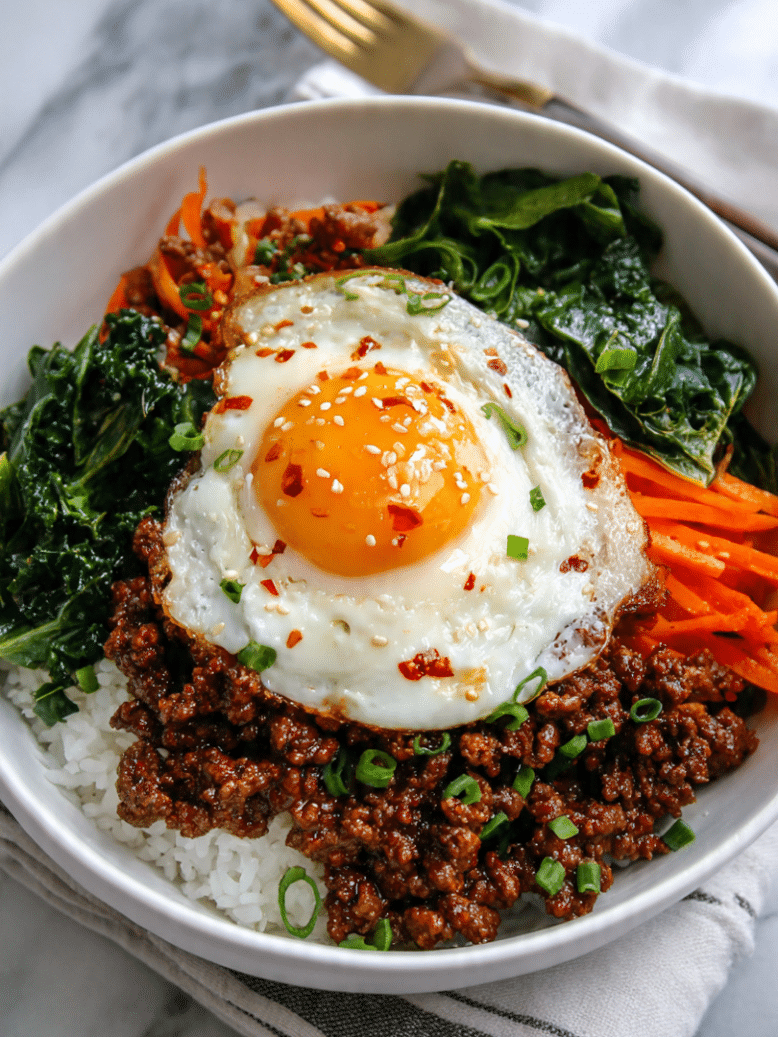 Korean ground beef bowl recipe served over rice with sesame seeds and green onions